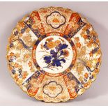 A JAPANESE IMARI PORCELAIN PLATE - decorated with bands of gilded floral decoration, 27cm