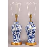 A PAIR OF CHINESE KANGXI STYLE BLUE & WHITE PORCELAIN VASE LAMPS - with panel decoration of