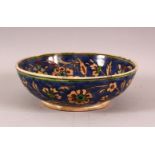 A DECORATIVE IZNIK STYLE POTTERY BOWL, painted with flowers and foliate decoration, 18.5cm