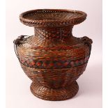 A JAPANESE MEIJI PERIOD WOVEN IKEBANA BASKET VASE - the woven basket with twin handles and a