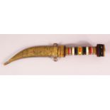 AN EASTERN HARDSTONE HANDLED BRASS SHEATH DAGGER - the hilt formed from stacked variations of hard