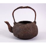 AN EARLY CHINESE BRONZE CIRCULAR KETTLE, with swing handle, 12cm diameter.