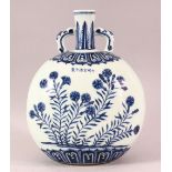 A CHINESE BLUE & WHITE TWIN HANDLE PORCELAIN FLASK VASE - decorated with scenes of flora, the top