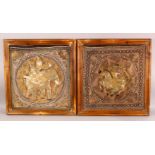 A PAIR OF FRAMED INDIAN EMBROIDERED PANELS, each centre with roundel depicting a figure on a horse
