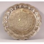 A SRI LANKAN POSSIBLY SILVER DISH, with embossed and chased decoration, 35cm diameter.