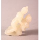 A EASTERN CARVED JADE PENDANT - EROTIC THEME - two figures during intercourse, 5.5cm