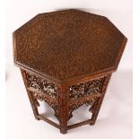 A FINE 19TH CENTURY INDIAN CARVED WOOD TRAVELLING FOLDING TABLE - the folding legs with finely
