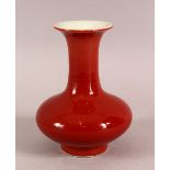 A SMALL CHINESE RED GROUND BOTTLE VASE, 15cm high.
