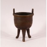 A SMALL 19TH CENTURY CHINESE TWIN HANDLE TRIPOD CENSER, the body with greek key decoration, 9.5cm