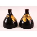 A PAIR OF JAPANESE MEIJI PERIOD SETO PORCELAIN VASES, each squat formed porcelain vase decorated