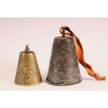 TWO BRONZE QAJAR CATTLE BELLS - each with raised lion decoration one with calligraphy, 11cm &