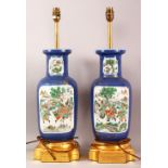 A PAIR OF CHINESE FAMILLE VERTE PORCELAIN VASES AS LAMPS, with panel decoration upon a blue gilt