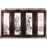 A SET OF FOUR CHINESE FAMILLE ROSE PORCELAIN FRAMED PANELS - each depicting figures seated in