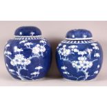 TWO 19TH / 20TH CENTURY CHINESE BLUE & WHITE PORCELAIN PRUNUS JARS & COVERS - each with prunus