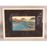 A JAPANESE FRAMED WOOD BLOCK PRINT - depicting figures in village life, 58cm x 48cm