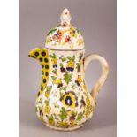 AN 18TH CENTURY TURKISH KUTAHYA POTTERY COFFEE POT - decorated with native floral decoration, 20cm