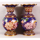 A PAIR OF CHINESE CLOISONNE VASES - with a deep royal blue ground depicting native flora and