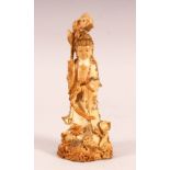 A CHINESE CARVED & POLYCHROME DECORATED IVORY FIGURE OF GUANYIN - stood holding flora and surrounded