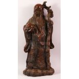 A LARGE CHINESE BRONZE STATUE OF A SAGE holding a peach in one hand and a staff in his other hand,