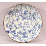 A LARGE CHINESE BLUE & WHITE PORCELAIN CHARGER - with decoration depicting immortal figures in a