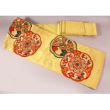 A FINE JAPANESE SILK EMBROIDERED FUKURO OBI TIE - upon a yello ground with red and green details