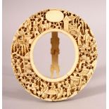 A 19TH CENTURY CHINESE CANTON CARVED IVORY OVAL FRAME, the frame finely carved with figures carrying