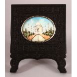 A SMALL INDIAN / CEYLONESE EBONY FRAME WITH IVORY PAINTED SCENE - the painting depicting the taj-