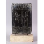 A MESOPOTAMIAN BABYLONIAN STYLE CARVED BLACK TABLET, carved with two figures and objects, with