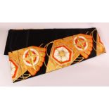 A FINE JAPANESE SILK EMBROIDERED FUKURO OBI TIE - upon a black ground with red orange & green