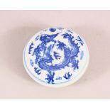 A CHINESE BLUE AND WHITE CIRCULAR PORCELAIN BOX, the inside painted with erotic scenes, four