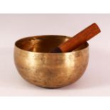 A 19TH CENTURY CHINESE TIBETAN BRASS MUSIC BOWL AND STICK - 17CM