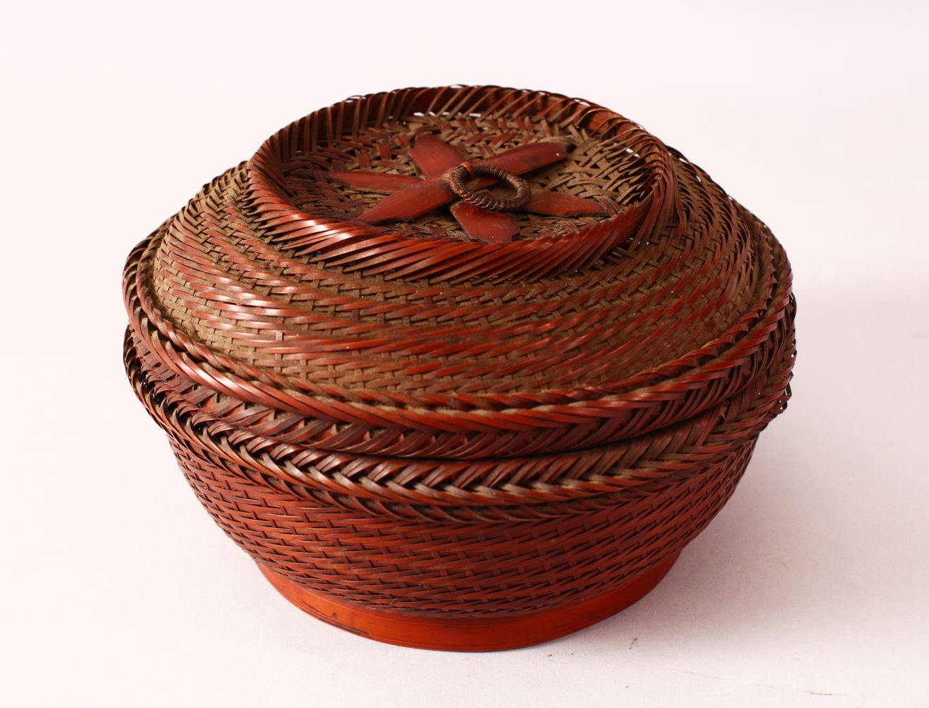 A JAPANESE MEIJI PERIOD WOVEN IKEBANA BASKET & COVER - of woven form with a ring handle, 19.5cm