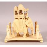 A FINE 19TH CENTURY INDIAN CARVED IVORY ELEPHANT GROUP, the elephant with covered howdah