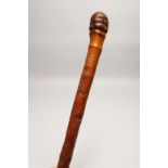 AN AFRICAN CARVED WALKING STICK 2ft 10ins long