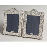 A PAIR OF SILVER PHOTOGRAPH FRAMES in Roccoco style 9ins x 5.5ins