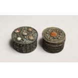 TWO ISLAMIC FILIGREE CIRCULAR BOXES set with hard stones 2ins & 1.75ins diameter