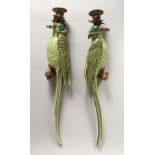 A PAIR OF ORNATE PORCELAIN AND ORMOLU WALL LIGHTS modelled as parrots seated on a tree stump.