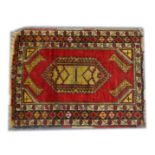 A SMALL PERSIAN/TURKISH RUG, red ground with central lozenge shape design (central join) 3ft 10ins x