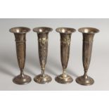 FOUR VERY SIMILAR STERLING SILVER FLOWER VASES 8ins high.