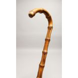 A RUSTIC WALKING STICK 2ft 7ins long