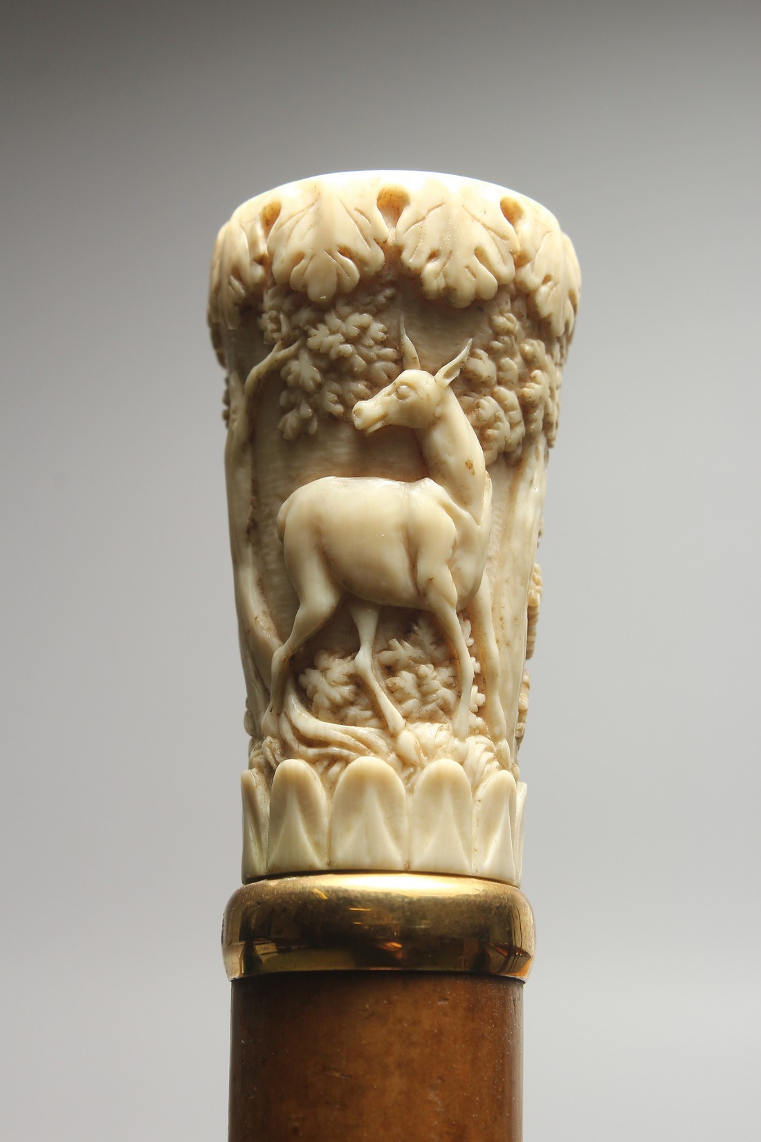 A 19TH CENTURY EUROPEAN WALKING CANE with carved ivory handle, deer in a landscape by BRIGG, LONDON.