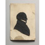AN EARLY 20TH CENTURY SILHOUETTE PORTRAIT BUST OF A GENTLEMAN, loosely mounted on a card printed