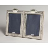 A PAIR OF SILVER PHOTOGRAPH FRAMES, with gadrooned borders 9ins x 5.5ins