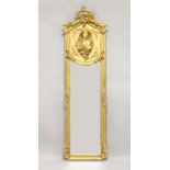 A DECORATIVE NARROW GILT FRAMED MIRROR the upper section decorated with the bust of a lady 5ft 10ins