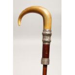 A VICTORIAN RHINO HANDLE UMBRELLA CANE with silver band Birmingham 1900