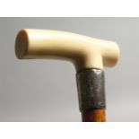 A GOOD VICTORIAN CARVED IVORY HANDLE WALKING STICK with silver band.
