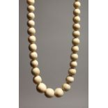A GOOD GRADUATED IVORY BEAD NECKLACE on ninety seven beads. 36ins long