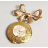 A URBEX 18CT GOLD NURSE'S FOB WATCH topped with a bow brooch