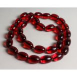 A LARGE STACK OF THIRTY TWO CHERRY BEADS.