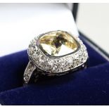 A SILVER CZ AND YELLOW RING